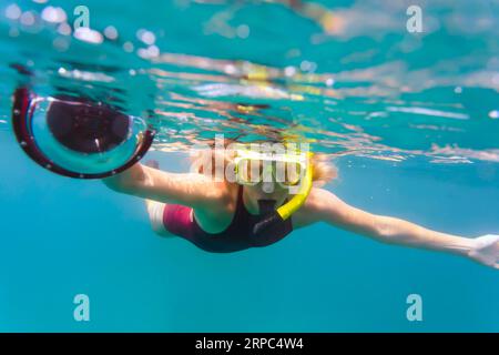 Femme snorkeling avec caméra sous-marine, Permuteran, Bali, Indonésie Banque D'Images