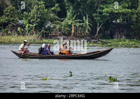 Des étudiants ruraux bangladais vont à l'école par un petit bateau à Banaripara à Barisal, Bangladesh. Banque D'Images