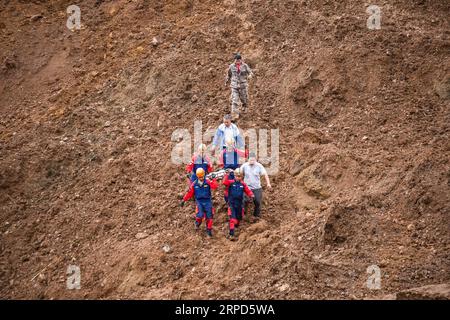 (190724) -- SHUICHENG, le 24 juillet 2019 -- des sauveteurs transfèrent le corps d'une victime sur un site de glissement de terrain dans le village de Pingdi, dans le comté de Shuicheng, dans la ville de Liupanshui, dans le sud-ouest de la Chine, dans la province du Guizhou, le 24 juillet 2019. Onze personnes sont mortes après un glissement de terrain qui a frappé le village de Pingdi mardi soir, ont déclaré mercredi les autorités locales. Vers 9:20 h (1320 h GMT) mardi, un glissement de terrain a frappé le village, enterrant 21 maisons. Plus de 50 personnes vivaient dans la zone touchée lorsque le glissement de terrain a frappé, selon les sauveteurs. Mercredi vers 11 heures (0300 heures GMT), 11 personnes ont été retrouvées mortes, 11 autres ont été secourues Banque D'Images