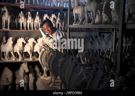 (190727) -- ZHENGZHOU, 27 juillet 2019 -- Gao Shuiwang, héritier de la technique de poterie vitrée tricolore, vérifie une poterie non émaillée dans un entrepôt dans le village de Nanshishan du comté de Mengjin dans la ville de Luoyang, province du Henan en Chine centrale, 23 juillet 2019. Sancai, ou poterie vitrée tricolore, est faite d'argile blanche et recouverte d'une couche de glaçure. La technique de production de Sancai, qui prévalait sous la dynastie Tang (618-907 AD), était très complexe et figurait parmi les héritages nationaux immatériels de la Chine en 2008. Gao Shuiwang, un maître artisan de 61 ans, s’est consacré au cours des quatre dernières années Banque D'Images