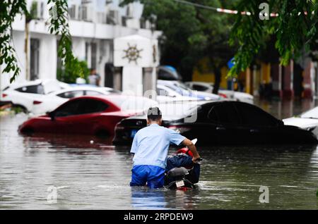 (190802) -- BEIJING, 2 août 2019 -- Un homme se déplace avec une moto sur une route inondée à Haikou, dans la province de Hainan du sud de la Chine, 1 août 2019. Wipha, le septième typhon de cette année, a touché terre vers 1:50 heures jeudi dans les régions côtières de la ville de Wenchang, dans la province de Hainan du sud de la Chine. ) PHOTOS XINHUA DU JOUR YangxGuanyu PUBLICATIONxNOTxINxCHN Banque D'Images