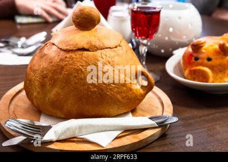 Soupe de bol de pain se tient sur une table dans un restaurant, photo en gros plan avec flou sélectif Banque D'Images