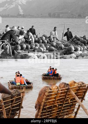 190920 -- PÉKIN, 20 septembre 2019 -- Haut : photo prise en 1954 par Hu Yue montre des passeurs utilisant des radeaux en peau de mouton pour transporter des fruits et des légumes sur le fleuve jaune à Lanzhou, dans la province du Gansu, au nord-ouest de la Chine. En bas : photo prise le 29 mai 2019 par des touristes prenant des radeaux en peau de mouton pour dériver sur le fleuve jaune au village de Longwan du comté de Jingtai dans le Baiyin du Gansu. Le radeau en peau de mouton, fait de peau de mouton gonflée, était un outil de transport important pour les habitants vivant le long des rives du fleuve jaune. Maintenant, il est devenu des véhicules populaires pour les touristes à visiter le long du RIV jaune Banque D'Images