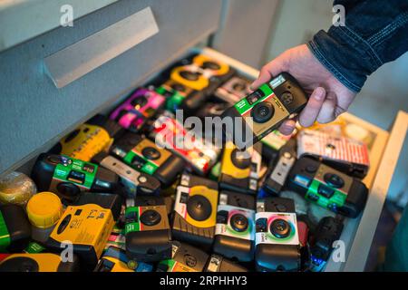 191109 -- BEIJING, 9 novembre 2019 -- Liu Gaochao montre une collection d'appareils photo jetables usagés de clients dans son studio à Beijing, capitale de la Chine, le 26 octobre 2019. Cela fait plus de cinq ans que Liu Gaochao a embrassé une carrière dans le développement cinématographique. Au sommet d'un manoir de grande hauteur à côté de la station Liufang de la ligne 13 du métro de Pékin, Liu gère un studio, New Wave film Lab, qui lui fournit également un endroit où vivre. En 2012, Liu a quitté sa ville natale dans la province du Henan au centre de la Chine et s est dirigé vers Pékin à la recherche de meilleures opportunités. Après s'être installé dans la capitale, il est tombé sur le cinéma Banque D'Images