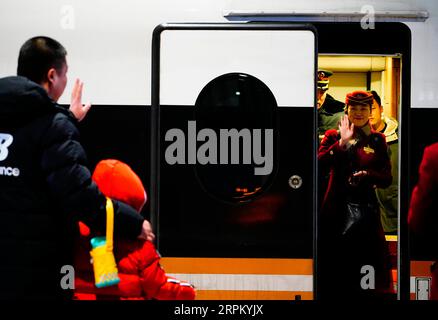 200121 -- SHIJIAZHUANG, le 21 janvier 2020 -- Li Qi R, front fait ses adieux à sa famille dans une gare de Shijiazhuang, dans la province du Hebei, dans le nord de la Chine, le 21 janvier 2020. La fête du printemps est la plus grande occasion de réunion de famille à travers la Chine, mais pour la famille de Zhang Anzhe, 6 ans, les occasions de réunion sont rares. Le père de Zhang, Zhang Peng, est policier au bureau de police de la gare de Shijiazhuang, tandis que sa mère Li Qi est chef de train entre Shijiazhuang et Wuhan. Les deux parents étaient tellement occupés pendant la période de pointe des voyages du Festival du printemps. Ils doivent nous faire Banque D'Images