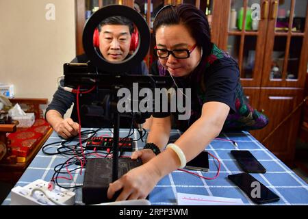 200310 -- TAIYUAN, le 10 mars 2020 -- Wu Lingyun et son épouse Wang Chunmei se préparent à interpréter l'opéra Jin en direct à Taiyuan, dans la province du Shanxi, dans le nord de la Chine, le 6 mars 2020. En raison des risques épidémiques de COVID-19, les représentations théâtrales sont suspendues. Wu Lingyun déplace sa scène de Jin Opera sur une plateforme de streaming en direct avec ses parents et sa femme, qui sont tous des interprètes célèbres de Jin Opera. L'opéra Jin est une forme d'art traditionnelle originaire de la province du Shanxi pendant les premières années de la dynastie Qing 1644-1911, en vedette pour son style de chant énergique. CHINA-SHANXI-JIN OPERA-PERFORMERS-LIVE Banque D'Images