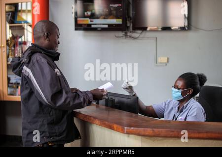 200319 -- KAMPALA, le 19 mars 2020 Xinhua -- Une réceptionniste portant un masque facial reçoit un client à Kampala, Ouganda, le 18 mars 2020. Le président ougandais Yoweri Museveni a annoncé mercredi une série de nouvelles mesures pour lutter contre la nouvelle maladie à coronavirus COVID-19 dans ce pays d’Afrique de l’est une fois qu’elle aura éclaté. L’Ouganda n’a pas encore enregistré de cas de COVID-19, mais le ministère de la Santé a déclaré qu’il était exposé à un risque élevé. Xinhua/Hajarah Nalwadda OUGANDA-KAMPALA-COVID-19-PRÉVENTION PUBLICATIONxNOTxINxCHN Banque D'Images