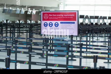 200420 -- TORONTO, le 20 avril 2020 -- de nouvelles exigences en matière de couvre-visage sont visibles à l'écran pendant l'épidémie de COVID-19 à l'aéroport international Pearson de Toronto, Canada, le 20 avril 2020. Le ministre canadien des Transports, Marc Garneau, a annoncé le 17 avril une nouvelle mesure qui entrera en vigueur le 20 avril, obligeant tous les passagers des compagnies aériennes à se couvrir la bouche et le nez avec un masque non médical ou un autre masque facial aux points de contrôle de l’aéroport. Photo de /Xinhua CANADA-TORONTO-COVID-19-MESURES ZouxZheng PUBLICATIONxNOTxINxCHN Banque D'Images