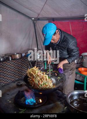 200513 -- MONT QOMOLANGMA, le 13 mai 2020 -- Un chef cuisinier cuisine au camp avancé à 6 500 mètres d'altitude sur le mont Qomolangma, le 10 mai 2020. Pour faire face à la haute altitude et à la basse pression au camp avancé, les chefs utilisent des autocuiseurs pour préparer la nourriture. InTibet CHINE-TIBET-MONT QOMOLANGMA-ADVANCE CAMP-MEAL CN SunxFei PUBLICATIONxNOTxINxCHN Banque D'Images