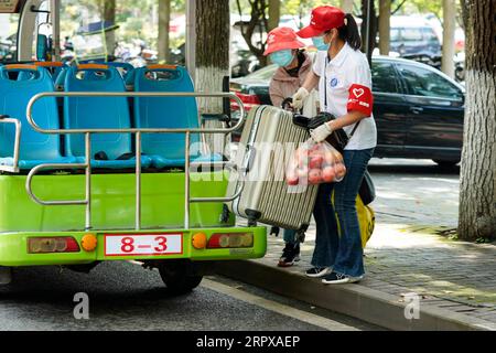 200515 -- CHONGQING, le 15 mai 2020 -- Un bénévole R aide un étudiant avec des bagages à l'Université Southwest à Chongqing, dans le sud-ouest de la Chine, le 15 mai 2020. L’Université du Sud-Ouest a accueilli le premier groupe d’étudiants de retour après l’épidémie. CHINE-UNIVERSITÉ DE CHONGQING-ROUVRIR CN LiuxChan PUBLICATIONxNOTxINxCHN Banque D'Images