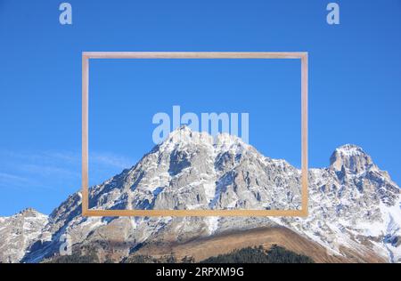 Cadre en bois et belles montagnes couvertes de neige Banque D'Images