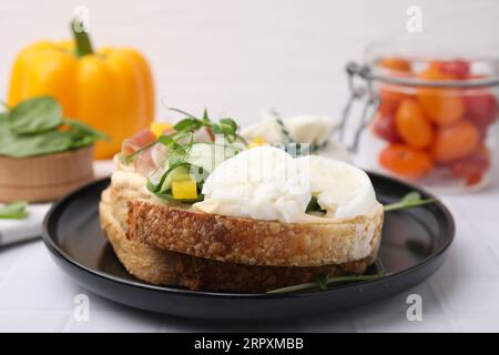 Savoureux sandwich avec du fromage burrata et des légumes sur la table blanche, gros plan Banque D'Images