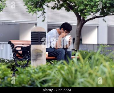 200729 -- HONG KONG, le 29 juillet 2020 Xinhua -- Un homme prend un repas dans un parc à Hong Kong, dans le sud de la Chine, le 29 juillet 2020. Des mesures de distanciation sociale plus strictes ont pris effet mercredi à Hong Kong. Les services de restauration dans les restaurants sont interdits. Xinhua/Lo Ping FAI CHINE-HONG KONG-COVID-19-MESURES DE DISTANCIATION SOCIALE CN PUBLICATIONxNOTxINxCHN Banque D'Images