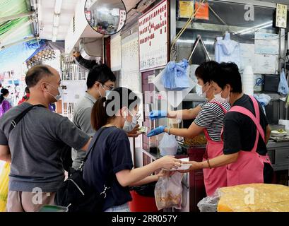 200729 -- HONG KONG, 29 juillet 2020 Xinhua -- des gens font la queue pour acheter des plats à emporter dans un restaurant de Hong Kong, dans le sud de la Chine, le 29 juillet 2020. Des mesures de distanciation sociale plus strictes ont pris effet mercredi à Hong Kong. Les services de restauration dans les restaurants sont interdits. Xinhua/Lo Ping FAI CHINE-HONG KONG-COVID-19-MESURES DE DISTANCIATION SOCIALE CN PUBLICATIONxNOTxINxCHN Banque D'Images