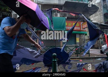 200819 -- MACAO, 19 août 2020 Xinhua -- Un homme marche dans une rue à Macao, dans le sud de la Chine, le 19 août 2020. La région administrative spéciale de Macao en Chine a abaissé son signal typhon du plus haut niveau n ° 10 au n ° 8 mercredi à 7:30 heures du matin, heure locale, mais les zones basses près de la côte ont été inondées, car le typhon Higos avait touché terre dans la ville voisine de Zhuhai dans la matinée. Le Bureau météorologique et géophysique de Macao avait amélioré son signal typhon au niveau n°10 mercredi à 5:00 heures, heure locale, avant de le déclasser au n°8 plus tard. L'avertissement d'onde de tempête rouge l'était aussi Banque D'Images