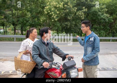 200830 -- PINGSHUN, 30 août 2020 -- Wang YapengR s'entretient avec des villageois du village de Nanpo, dans le comté de Pingshun, province du Shanxi, dans le nord de la Chine, le 20 août 2020. Wang Yapeng, 22 ans, est retourné dans sa ville natale de Nanpo Village pour démarrer son entreprise après avoir obtenu son diplôme de l’Université normale de Taiyuan cet été. Avec une expérience personnelle du commerce électronique qu’il a acquise à l’université et des soutiens techniques offerts par les autorités locales, Wang a repris une coopérative de plantation dans le village de Nanpo après en avoir discuté avec sa famille. Nanpo Village est un village agricole typique avec une longue histoire de plantation de millets et codonopsis Banque D'Images