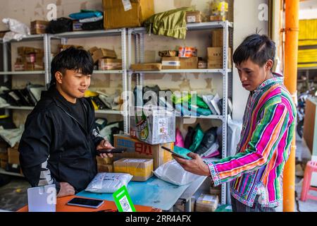 201127 -- KUNMING, le 27 novembre 2020 -- Li Bin R, résident de Dulong, récupère son colis dans un centre de services de commerce électronique dans la municipalité de Dulongjiang, Gongshan Dulong et le comté autonome de nu, dans le sud-ouest de la province du Yunnan, le 30 octobre 2020. Dulong est un groupe ethnique montagnard du sud-ouest de la Chine. Elle est l une des moins peuplées des 56 nationalités minoritaires de Chine. Il est également appelé un groupe ethnique minoritaire de transition directe parce que le peuple Dulong n a pas fait ses adieux à la vie primitive jusqu'à la fondation de la République populaire de Chine en 1949 et depuis lors, ils sont directement entrés dans la société Banque D'Images