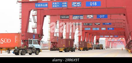 210303 -- NINGBO, 3 mars 2021 -- les camions porte-conteneurs livrent des conteneurs au port de Ningbo Zhoushan à Ningbo, dans la province du Zhejiang de l'est de la Chine, le 3 mars 2021. Le débit de fret et de conteneurs du port de Ningbo Zhoushan a enregistré une croissance annuelle de 4,7 pour cent et 4,3 pour cent respectivement en 2020. Le port a vu son débit de fret atteindre 1,172 milliards de tonnes tandis que le débit de conteneurs a atteint 28,72 millions d'équivalents vingt pieds EVP l'année dernière. CHINE-ZHEJIANG-NINGBO-PORT-DÉBIT CN WENGXXINYANG PUBLICATIONXNOTXINXCHN Banque D'Images