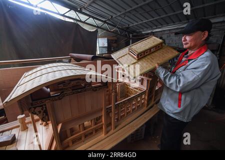 210417 -- HANGZHOU, le 17 avril 2021 -- Han Minghua vérifie une maquette du bateau rouge à l'atelier de Jiaxing Minghua Ship Model Manufacturing Co., Ltd. Dans la ville de Yuxin de la ville de Jiaxing, province de Zhejiang dans l'est de la Chine, le 13 avril 2021. Sur le lac Nanhu dans le Zhejiang repose l'un des bateaux les plus célèbres dans le pays - le bateau rouge. Chaque jour, de nombreux visiteurs font la queue pour rendre hommage au bateau historique, qui honore la conclusion du premier Congrès national du PCC du Parti communiste chinois en 1921. Pour marquer le 100e anniversaire du CPC, Han Minghua, héritier du modèle de bateau rouge, Banque D'Images