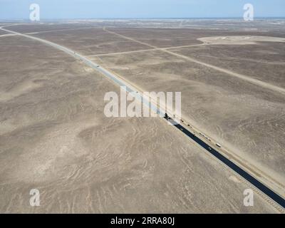 210720 -- FUHAI, le 20 juillet 2021 -- sur cette photo aérienne, des véhicules pavent une section d'une autoroute transdésertique avec de l'asphalte dans la région autonome ouïgoure du Xinjiang du nord-ouest de la Chine, le 16 juillet 2021. La construction de la première voie express transdésertique au Xinjiang s'est déroulée sans heurts. La voie express, qui relie la préfecture d'Altay et la capitale régionale d'Urumqi, s'étend sur quelque 343 km, avec des sections de plus de 150 km construites à travers le désert. CHINE-XINJIANG-CROSS-DESERT EXPRESSWAY CONSTRUCTION CN GAOXHAN PUBLICATIONXNOTXINXCHN Banque D'Images