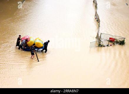 Chine, Überschwemmungen durch Starkregen in Zhengzhou 210721 -- ZHENGZHOU, 21 juillet 2021 -- des citoyens transportent leur propriété dans une rue inondée à Zhengzhou, dans la province du Henan du centre de la Chine, le 21 juillet 2021. Les pluies torrentielles ont envahi la province du Henan en Chine centrale depuis le week-end. CHINE-HENAN-ZHENGZHOU-FORTES PRÉCIPITATIONS CN ZHUXXIANG PUBLICATIONXNOTXINXCHN Banque D'Images