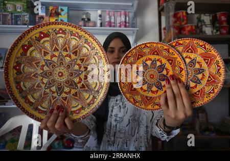 210810 -- JENIN, 10 août 2021 -- Diaa Sbehat expose des œuvres d'art en céramique faites à la main avec des peintures de motifs islamiques dans son atelier dans la ville de Jénine en Cisjordanie, le 10 août 2021. Sbehat était diplômée de l'Université ouverte Al-Quds avec un baccalauréat en technologie de l'information et de la communication avant de commencer à fabriquer des décorations en céramique. Elle gagne sa vie en vendant ses œuvres sur les réseaux sociaux. Photo de /Xinhua MIDEAST-JENIN-CERAMIC ART NidalxEshtayeh PUBLICATIONxNOTxINxCHN Banque D'Images