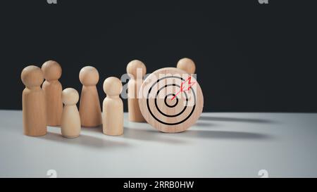 Concept cible des affaires et du personnel dans une entreprise. Poupées en bois debout autour du tableau de fléchettes et des flèches pour créer et cibler objectiv d'affaires Banque D'Images