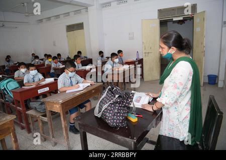 210913 -- AGARTALA, 13 septembre 2021 -- les élèves de l école Umakanta English Medium assistent à des cours avec des masques faciaux le premier jour de la réouverture des écoles de la classe 1 à la classe 5 après un relâchement dans les restrictions COVID-19 à Agartala, la capitale de l État de Tripura, au nord-est de l Inde, le 13 septembre 2021. Str/ INDIA-AGARTALA-RÉOUVERTURE DE L'ÉCOLE Xinhua PUBLICATIONxNOTxINxCHN Banque D'Images