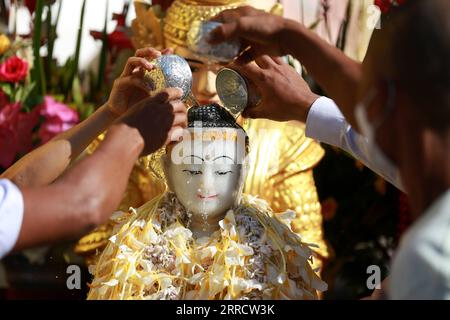 211118 -- YANGON, le 18 novembre 2021 -- des dévots versent de l'eau sur une statue de Bouddha lors du festival traditionnel Tazaungdaing à la pagode Shwedagon à Yangon, Myanmar, le 18 novembre 2021. Le Festival de Tazaungdaing, également connu sous le nom de Festival des Lumières, tombe au huitième mois du calendrier traditionnel du Myanmar. Il est célébré comme une fête nationale au Myanmar. MYANMAR-YANGON-TRADITIONAL TAZAUNGDAING FESTIVAL UxAung PUBLICATIONxNOTxINxCHN Banque D'Images