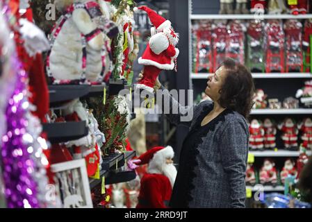 211212 -- BEYROUTH, 12 décembre 2021 -- Une femme magasine pour des décorations de Noël dans un magasin de Beyrouth, au Liban, le 11 décembre 2021. Les Libanais moyens ont ressenti la pincée de l'inflation dans le pays, après que sa monnaie a commencé à se déprécier par rapport au dollar américain il y a deux ans, lorsque le pays est entré dans une crise économique. POUR ALLER AVEC l'article : les Libanais se sentent pincés de l'inflation causée par la crise alors que Noël approche LIBAN-BEYROUTH-INFLATION BilalxJawich PUBLICATIONxNOTxINxCHN Banque D'Images