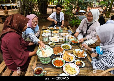 220401 -- SOUTH TANGERANG, le 1 avril 2022 -- les gens dînent dans un restaurant nommé Warung Tuman à South Tangerang, Indonésie, le 1 avril 2022. Situé dans les bois, ce restaurant est localement célèbre pour ses cuisines javanaise et de Sumatra occidental. Les populations locales et les gens des villes voisines telles que Jakarta viennent ici pour profiter de la nourriture dans l'étreinte de la nature. INDONÉSIE-SUD TANGERANG-LIFESTYLE XuxQin PUBLICATIONxNOTxINxCHN Banque D'Images