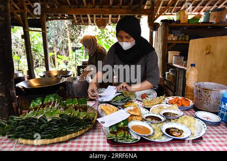220401 -- SOUTH TANGERANG, le 1 avril 2022 -- des membres du personnel préparent des repas pour les convives dans un restaurant nommé Warung Tuman à South Tangerang, Indonésie, le 1 avril 2022. Situé dans les bois, ce restaurant est localement célèbre pour ses cuisines javanaise et de Sumatra occidental. Les populations locales et les gens des villes voisines telles que Jakarta viennent ici pour profiter de la nourriture dans l'étreinte de la nature. INDONÉSIE-SUD TANGERANG-LIFESTYLE XuxQin PUBLICATIONxNOTxINxCHN Banque D'Images