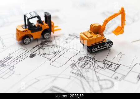 La machine de construction de jouet construit le modèle de la maison aux dessins. Banque D'Images