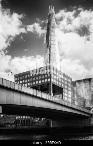 Image en noir et blanc de l'emblématique gratte-ciel de 310 mètres de haut, 87 étages, à façade vitrée, The Shard, debout à côté de London Bridge sur la Tamise Banque D'Images