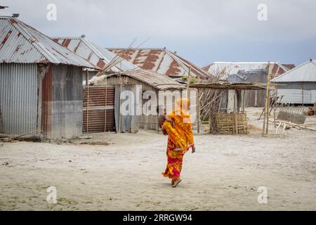 La ligne de crue - marques de l'eau de crue - est jusqu'à ce que visible sur toutes les maisons dans le char Kheyar. Les personnes qui vivent dans les SCAR - îles sédimentaires temporaires dans les grands fleuves du Bangladesh - sont particulièrement vulnérables aux événements météorologiques causés par le changement climatique. L'ONG Friendship a divers programmes de sensibilisation pour aider à atténuer les impacts. Banque D'Images