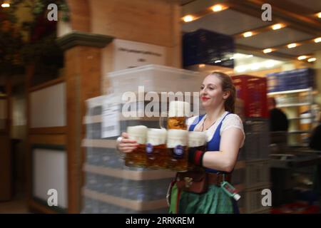 220918 -- MUNICH, le 18 septembre 2022 -- un membre du personnel sert de la bière le jour d'ouverture de l'Oktoberfest 2022 à Munich, Allemagne, le 17 septembre 2022. L’Oktoberfest, le plus grand festival folklorique d’Allemagne, a débuté samedi à Munich après une pause de deux ans induite par le COVID. Le festival devrait recevoir des millions de visiteurs du monde entier avec des bières spéciales Oktoberfest et des spécialités copieuses comme des saucisses frites et des jointures de porc. ALLEMAGNE-MUNICH-OKTOBERFEST-ROUVRIR ShanxWeiyi PUBLICATIONxNOTxINxCHN Banque D'Images