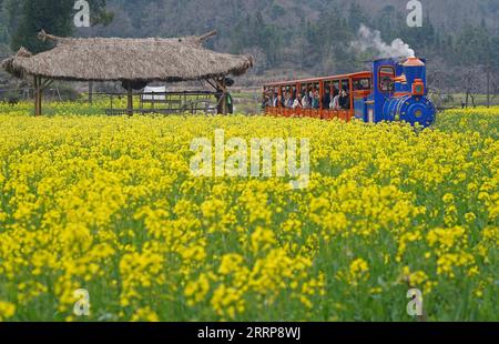 230304 -- SHANGRAO, le 4 mars 2023 -- les gens prennent un train touristique dans un endroit pittoresque du comté de Wuyuan, dans la province du Jiangxi de l'est de la Chine, le 3 mars 2023. Paysage printanier à Wuyuan attire beaucoup de visiteurs avec la hausse de la température. CHINA-JIANGXI-WUYUAN-SPRING CN WanxXiang PUBLICATIONxNOTxINxCHN Banque D'Images
