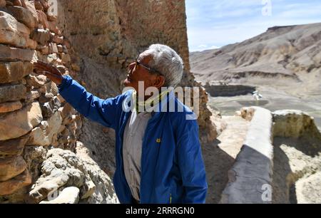 230528 -- ZANDA, le 28 mai 2023 -- Rigzin Wangzhab inspecte une grotte dans le comté de Zanda, préfecture de Ngari, région autonome du Tibet du sud-ouest de la Chine, le 26 mai 2023. Caché parmi les collines de grès dans l'ouest reculé du Tibet, une étendue de cavernes en forme de nid d'abeille est bien au-delà de la portée de la plupart des voyageurs. Connues sous le nom de grottes de Donggar et de Piyang, les cavernes vieilles de 1 000 ans de la préfecture de Ngari de la région autonome du Tibet abritent l une des plus grandes collections de peintures murales bouddhistes tibétaines au monde. Rigzin Wangzhab, 75 ans, garde le site depuis plus de 20 ans. Quand j'étais très jeune, on m'a dit que t Banque D'Images