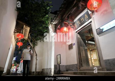 230615 -- FUZHOU, le 15 juin 2023 -- Un touriste passe devant l'ancienne résidence de Yan Fu, penseur, éducateur et traducteur chinois renommé, à Sanfangqixiang les trois voies et les sept ruelles à Fuzhou, dans la province du Fujian du sud-est de la Chine, le 9 juin 2023. Sanfangqixiang, ou les trois voies et sept ruelles, est un complexe de 40 hectares célèbre pour son tissu urbain traditionnel de ruelles et ruelles. Les allées en ardoise verte sont bordées de maisons ancestrales, avec des murs blancs et des carreaux noirs. Initialement construit dans la dynastie Jin 265-420, le quartier s'est développé dans la dynastie Tang 618-907 et les cinq Dyn Banque D'Images