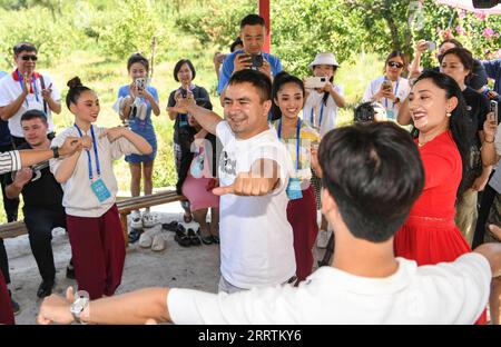 230730 -- URUMQI, 30 juillet 2023 -- des membres de la troupe de danse de l'Institut Bunditpatanasilpa de Thaïlande et des membres de la troupe d'art Muqam du théâtre d'art du Xinjiang dansent ensemble au théâtre d'art du Xinjiang à Urumqi, dans le nord-ouest de la Chine, région autonome ouygur du Xinjiang, le 24 juillet 2023. Sur le thème rêves de danse, harmonie de la route de la soie, le 6e Festival international de danse du Xinjiang de Chine a attiré plus de 1 000 artistes de pays et régions d'Asie, d'Europe et d'Afrique, et ils devraient présenter quelque 60 spectacles bien connus. CHINE-XINJIANG-URUMQI-DANSE FESTIVAL-ÉCHANGE CULTUREL CN HUXHU Banque D'Images