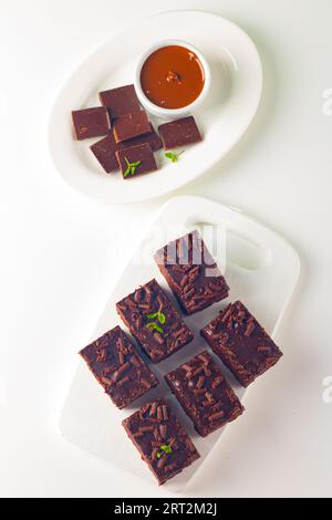 Délicieux brownies au chocolat avec de la menthe sur fond blanc. Concept de gâteau sucré. Banque D'Images