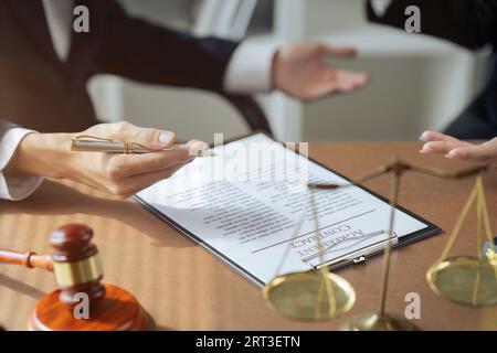 Close up of businessman or lawyers discussing about signing his signature on contract Stock Photo