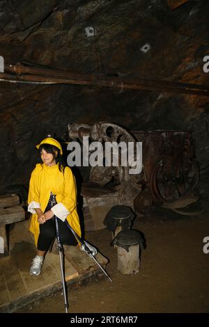 une vieille femme marche à l'intérieur d'une grotte Banque D'Images