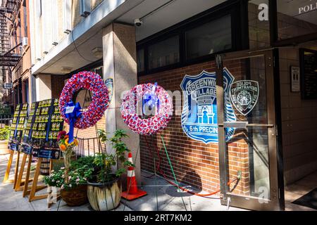 Souvenir de 9/11 au poste de la 6e circonscription avec des couronnes et la liste des policiers perdus le 11 septembre 2001, 10th St. Greenwich Village, New York Banque D'Images