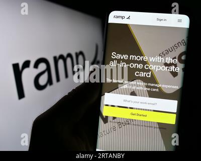 Personne tenant le smartphone avec la page Web de la société de logiciels américaine Ramp Business Corporation sur l'écran avec logo. Concentrez-vous sur le centre de l'écran du téléphone. Banque D'Images