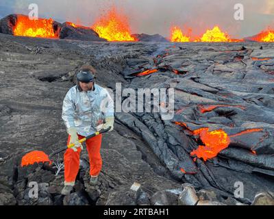 Kilauea, États-Unis. 11 septembre 2023. Les géologues de l’Observatoire des volcans d’Hawaï, portant un équipement de protection, prélèvent des échantillons à l’intérieur du sommet de la caldeira du Kilauea au parc national des volcans d’Hawaï, le 11 septembre 2023 à Kilauea, Hawaii. Le volcan, l’un des plus actifs de la planète, a commencé à entrer en éruption après une pause de deux mois. Crédit : Matthew Patrick/USGS/Alamy Live News Banque D'Images