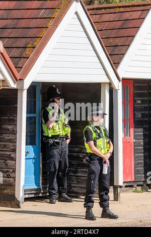 deux policiers à l'ombre du soleil en utilisant une cabane de plage. deux agents de police en patrouille à l'abri du soleil chaud en utilisant une cabane de plage en bord de mer. Banque D'Images