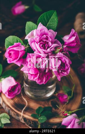 Bouquet de petites roses roses de jardin dans un vase en verre. Vue grand angle Banque D'Images