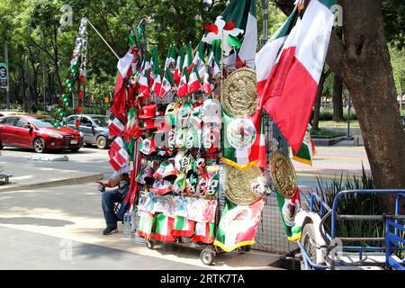 Mexico, Mexique - 6 septembre 2023 : Stall de rue vendant des drapeaux tricolores mexicains, des roues d'épingle, des chapeaux et d'autres articles nationaux Banque D'Images