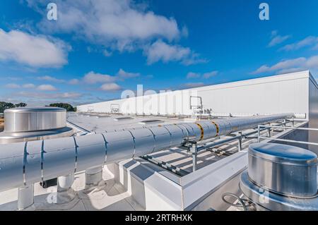 Vue du toit d'une nouvelle installation de stockage frigorifique, montrant des boîtiers en acier inoxydable et une tuyauterie isolée. Banque D'Images